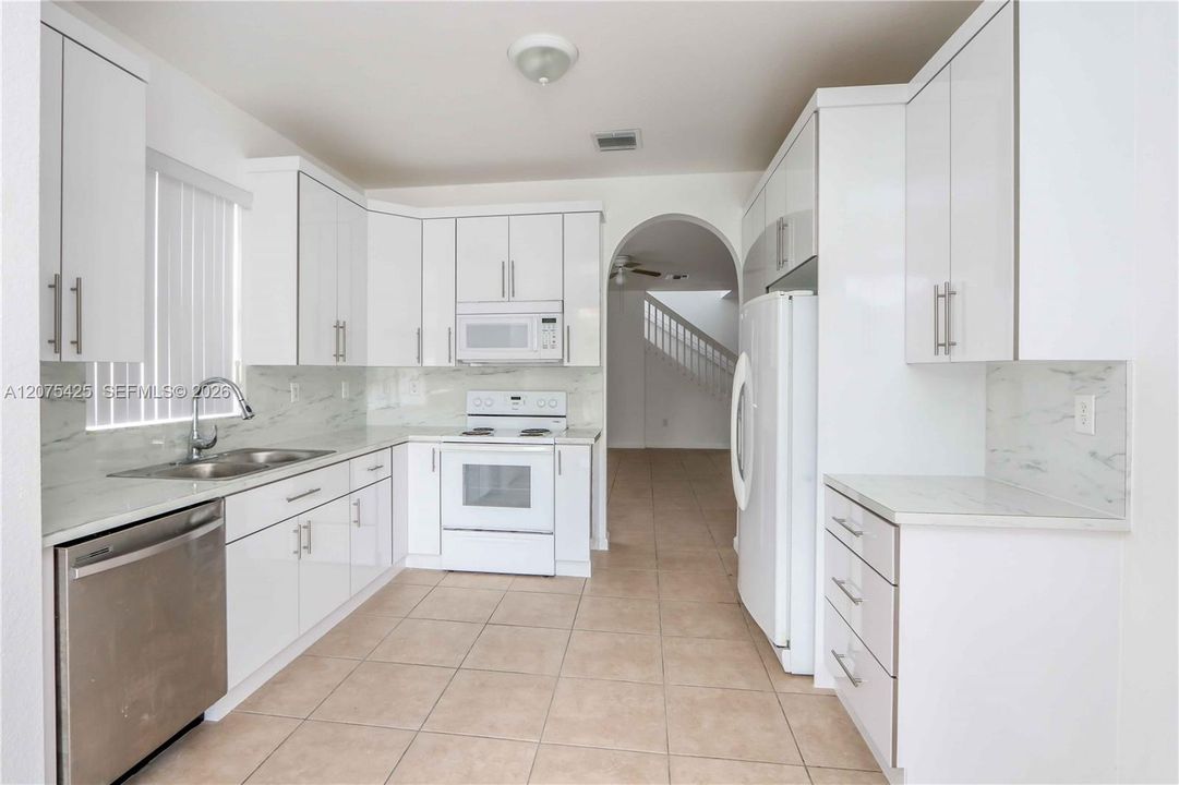 Alternate kitchen angle with white cabinetry.
