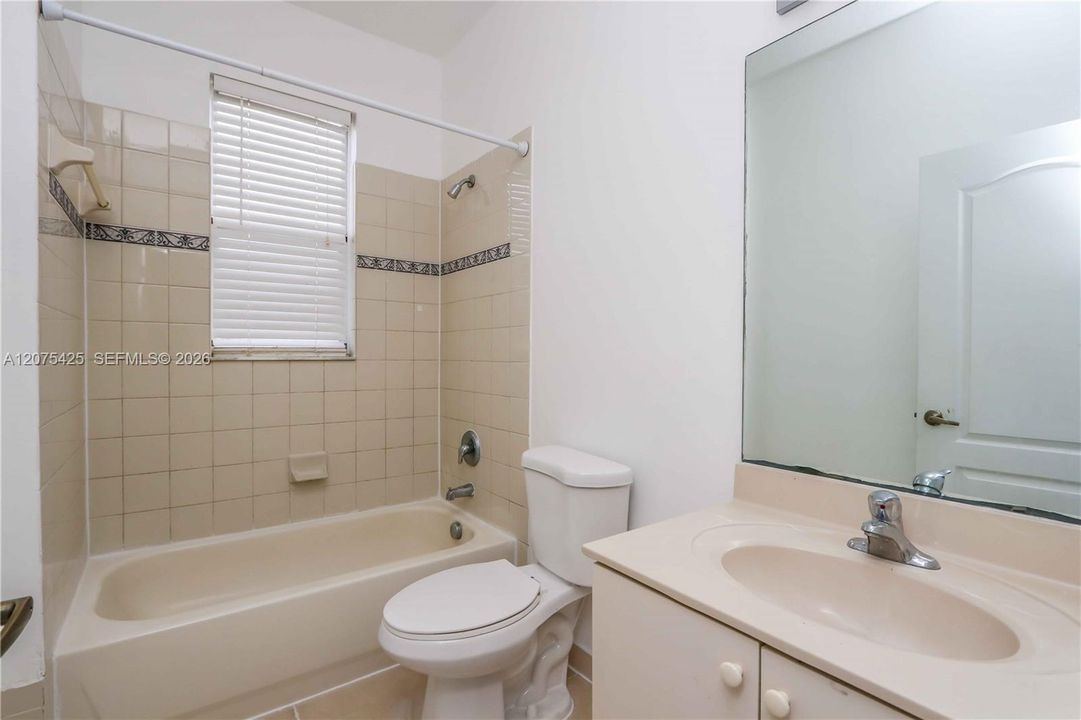 Cozy bathroom interior with vanity and mirror.