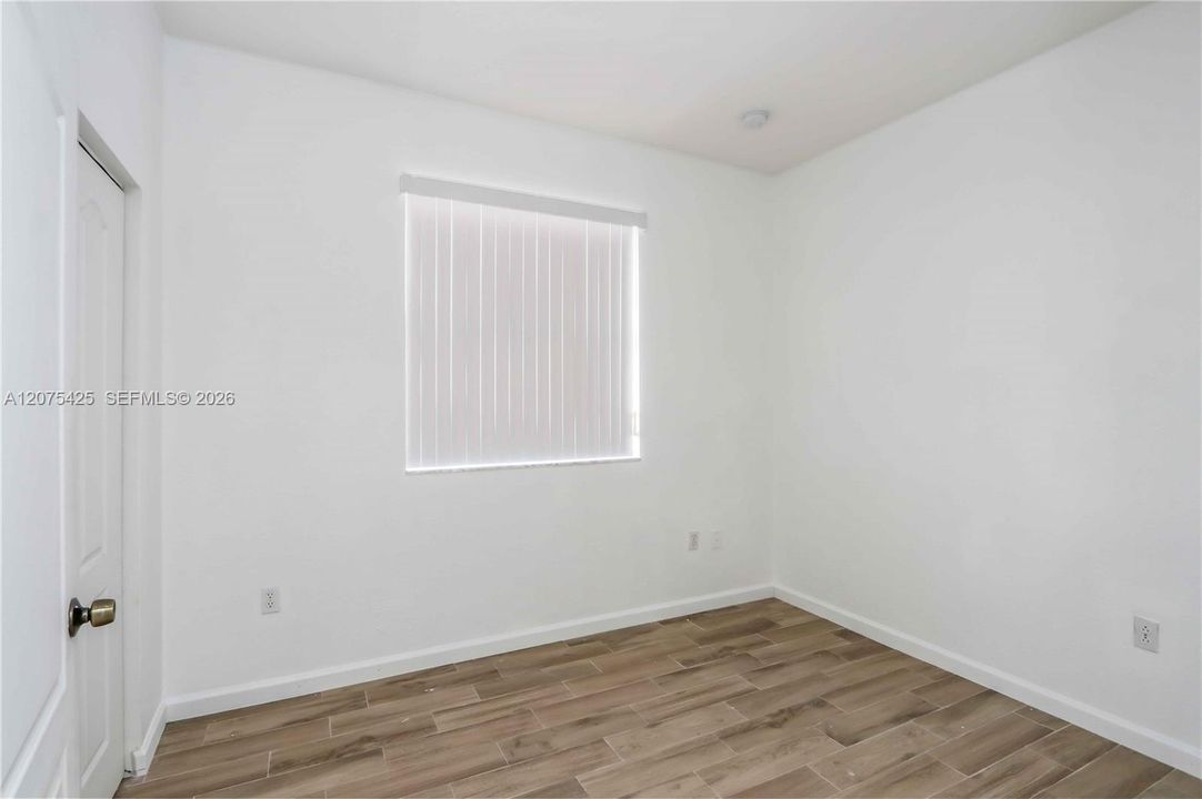 Spacious and well-lit bedroom interior.