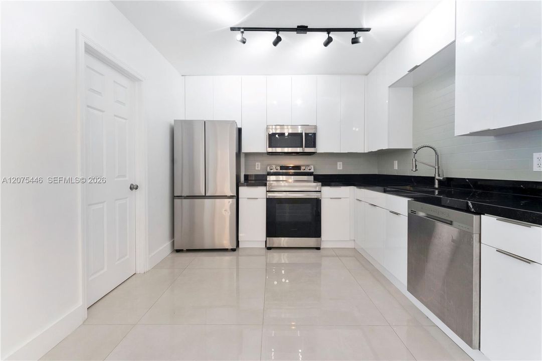 Modern kitchen with stainless steel appliances.