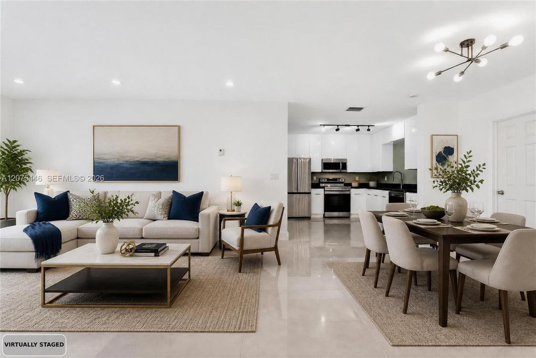 Virtually staged open-concept living, dining, and kitchen area showcasing the home's spacious layout.