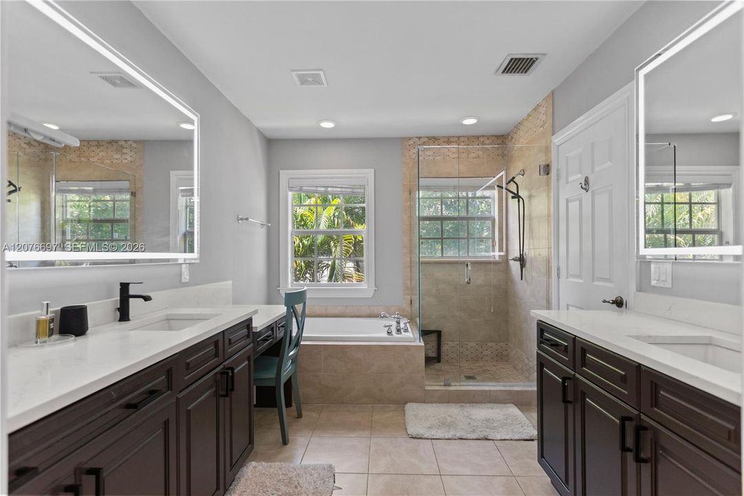 Dual Sinks with large vanity and counters. Lighted Mirrors over each sink.