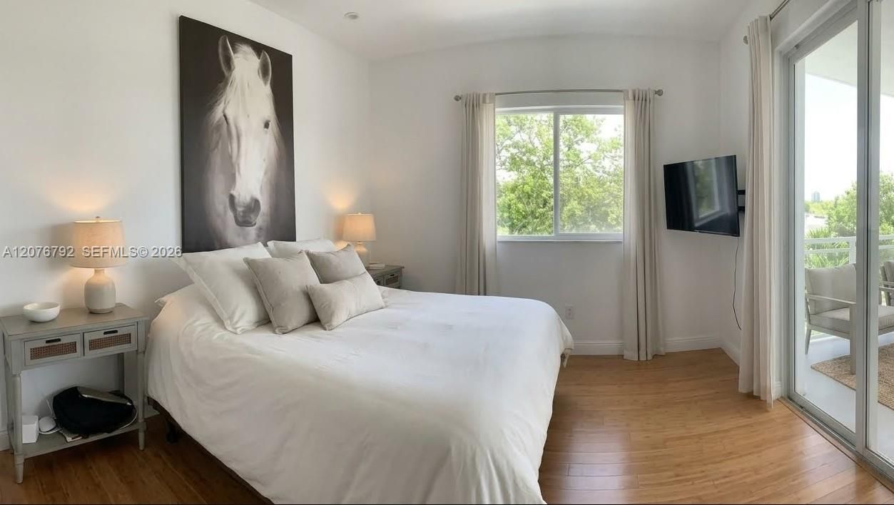 large primary bedroom with balocny access and corner exposure including window
