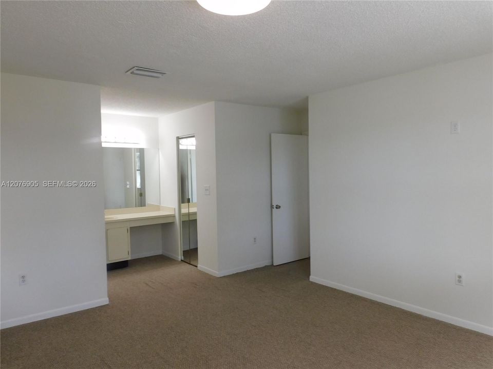 Primary Bedroom view to Entry Way and Vanity.