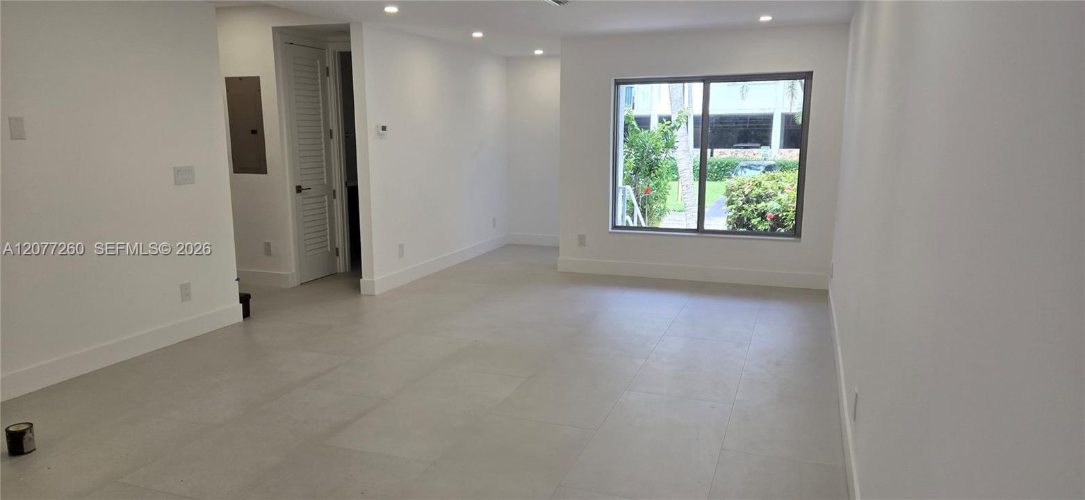 Interior view from living area to front entry. Full bathroom on the main floor.