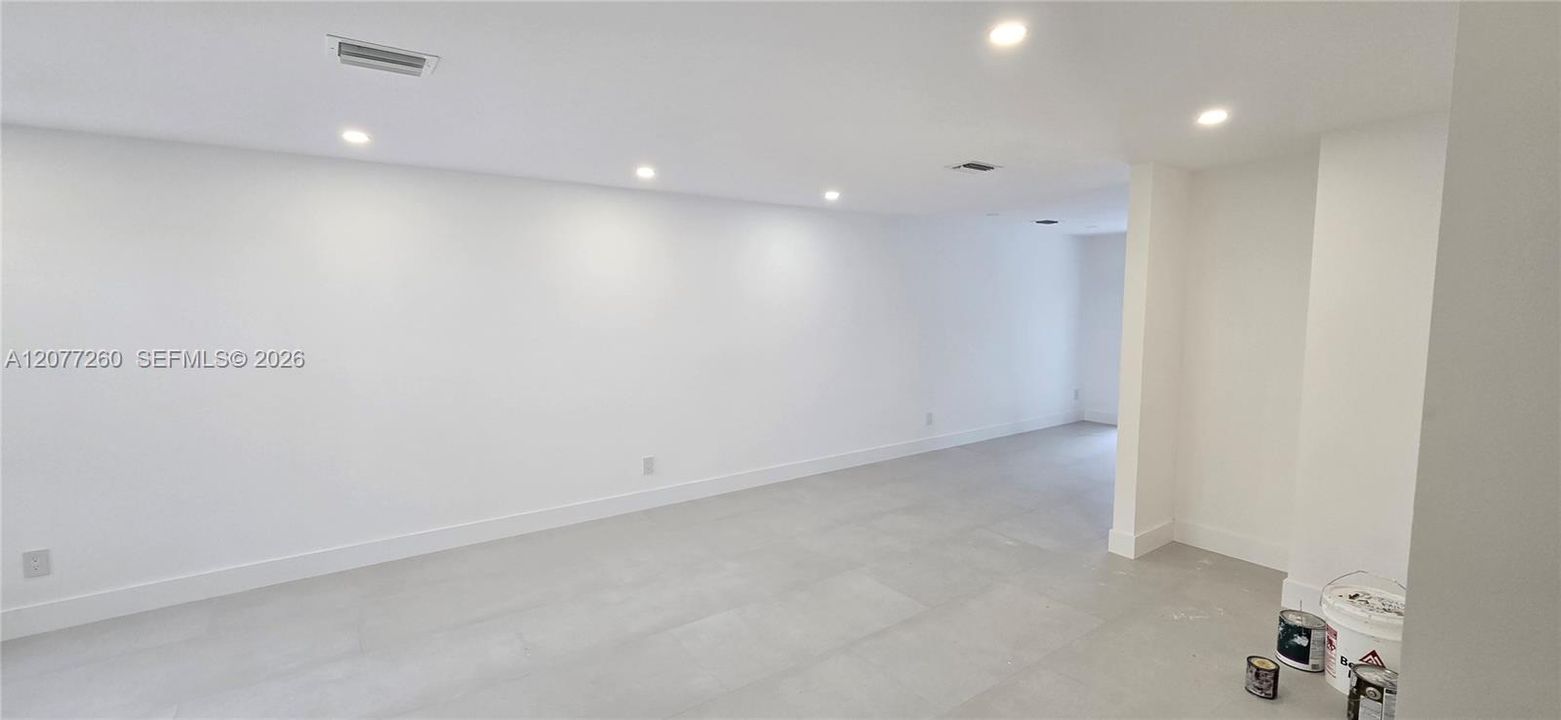 Spacious living room integrated with dining area.