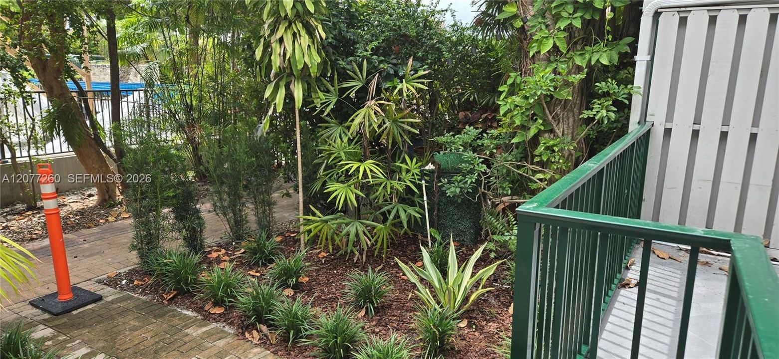 Private patio accessed from kitchen/dining area enhanced with lush tropical landscaping.