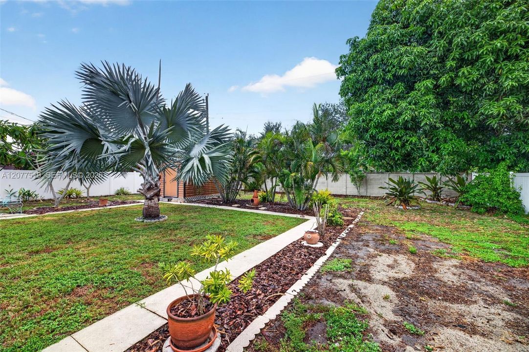 Spacious side yard provides additional outdoor space and convenient property access.