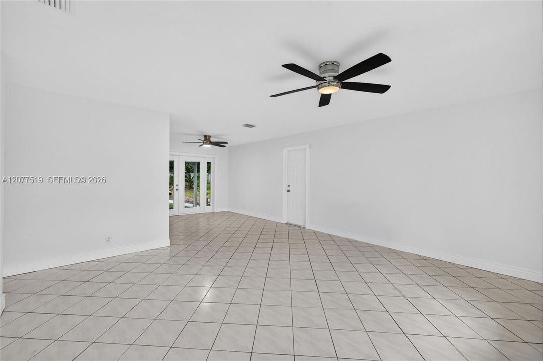 Bright living room featuring tile flooring, neutral finishes and ample natural light.