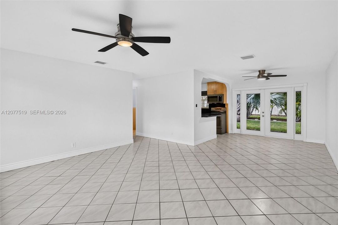 Comfortable living area with updated flooring, blinds and an open, inviting feel.