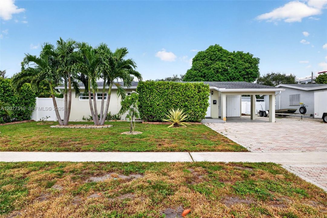 Wide driveway offers ample parking for multiple vehicles.