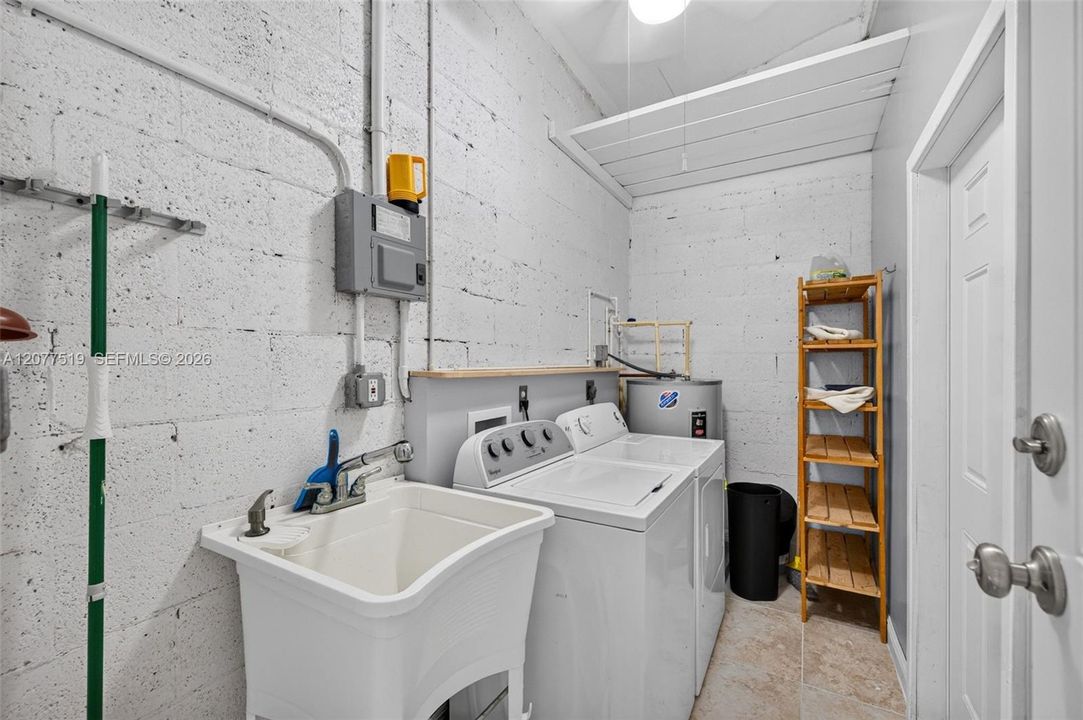 Convenient air-conditioned laundry room providing additional storage and workspace.