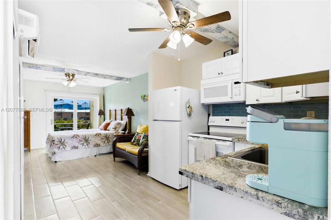 THE PALM ROOM Each thoughtfully designed studio features an open bedroom and living area, creating a comfortable and functional space with a fresh coastal feel.