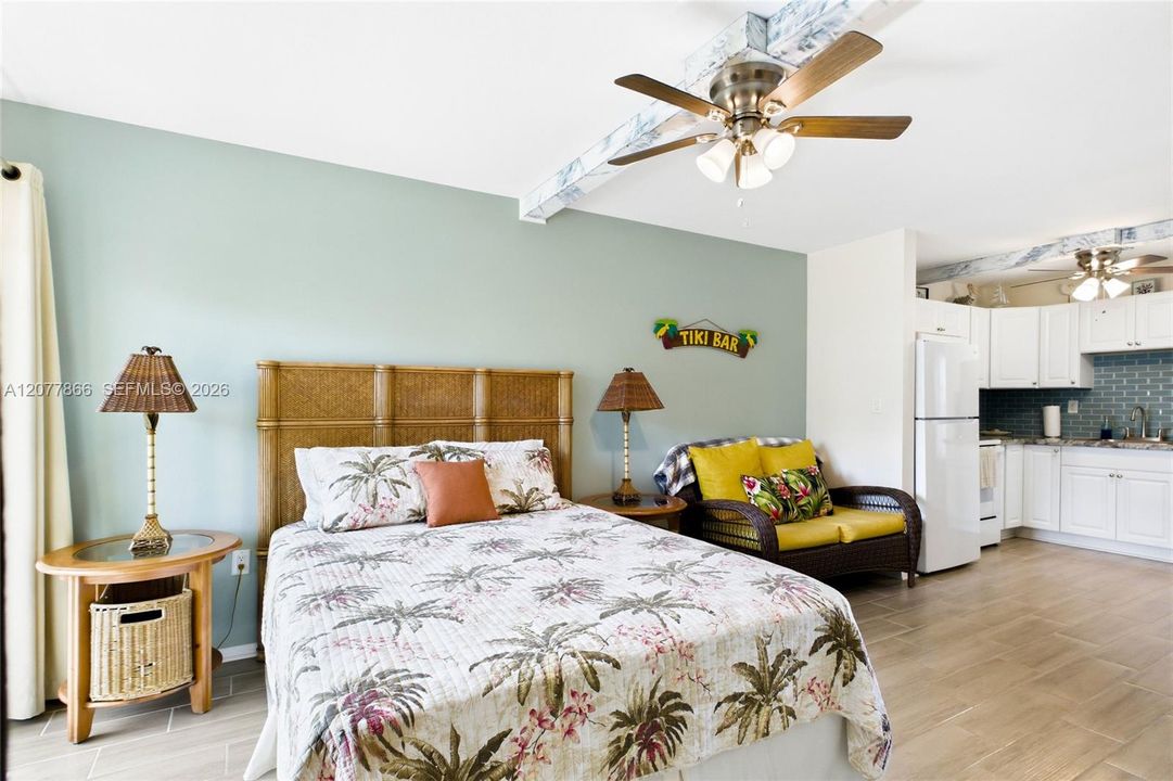 THE PALM ROOM Spacious and welcoming bedroom area complements the open studio-style layout.