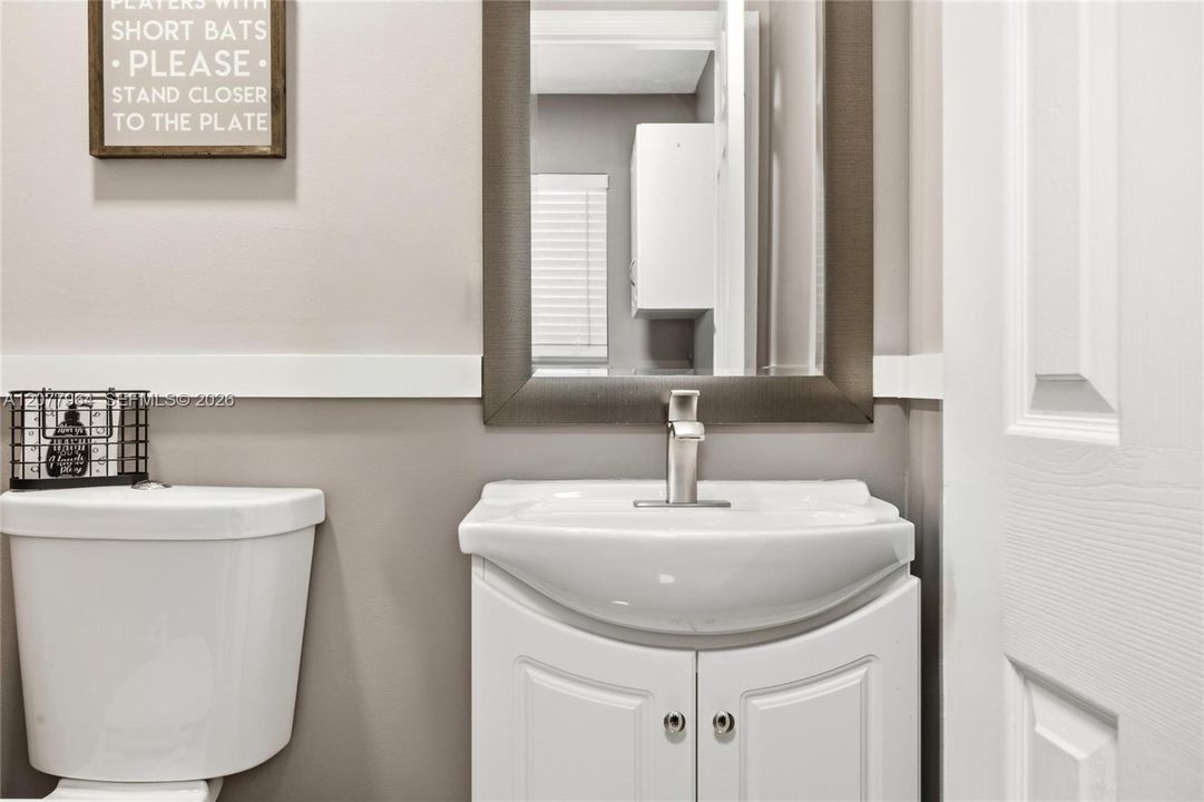 1/2 BATHROOM OFF LAUNDRY ROOM AND FAMILY ROOM