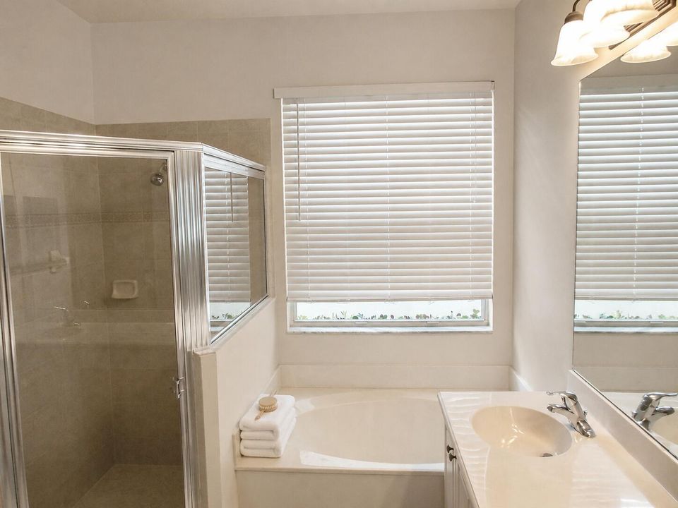 Warm neutral tub-shower with folded towe