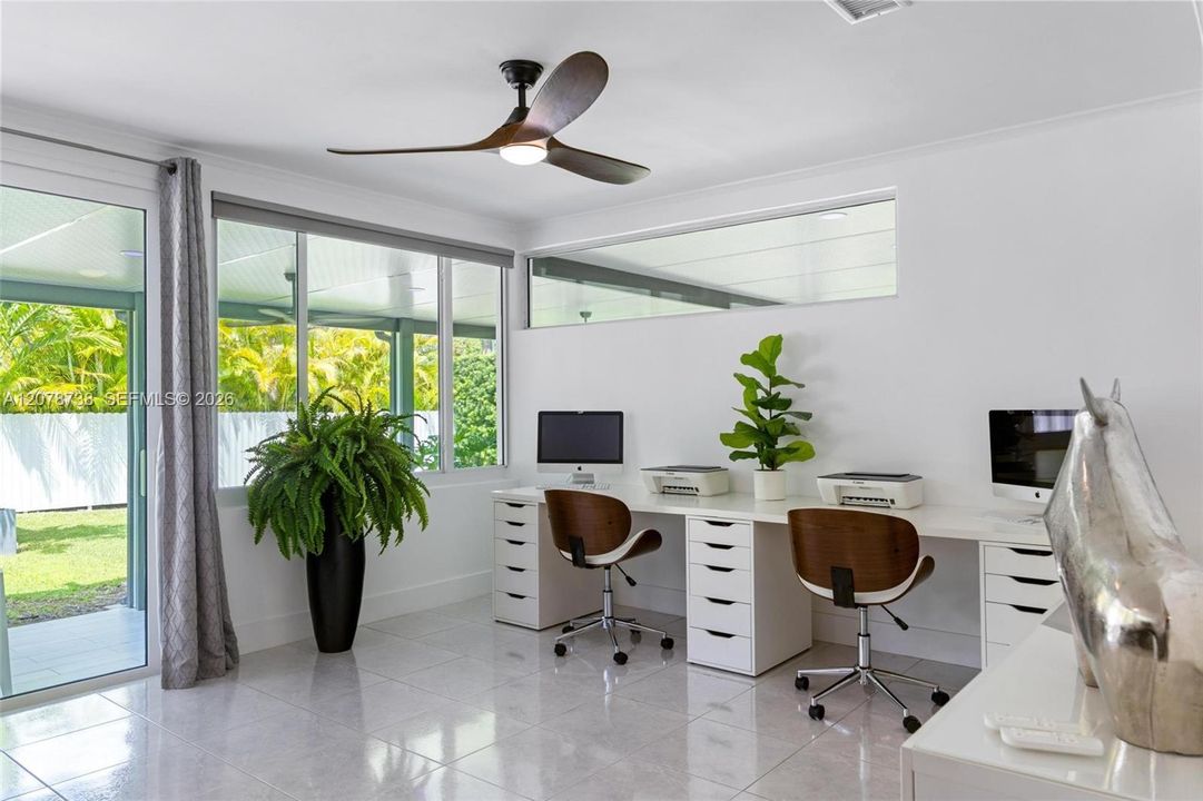 A dedicated workspace surrounded by natural light proves productivity doesn’t have to feel tucked away.