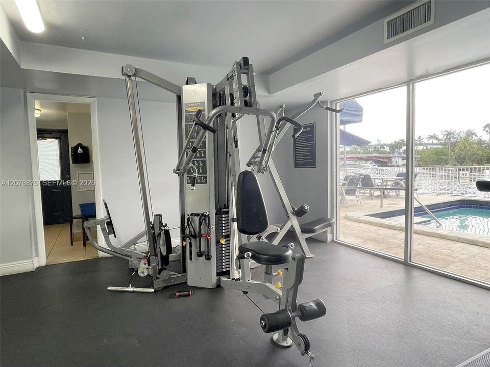 Modern gym with pool/river view