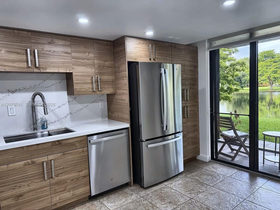 Recently remodeled kitchen with stainless steel appliances and a pantry section.