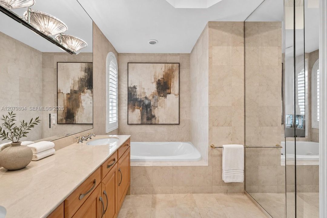 Virtually enhanced photo of the same primary bathroom, cleaned up