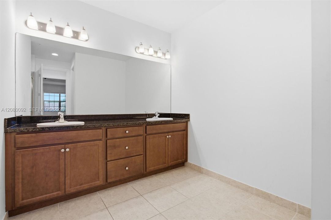 Master Bathroom with Well Lit Double Basins