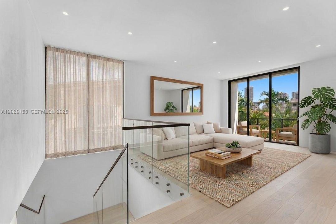 Upstairs Family Room. Disclaimer: Several photographs presented in this listing contain digitally added furniture, artwork, and decor. These virtually staged images are intended solely for illustrative purposes.