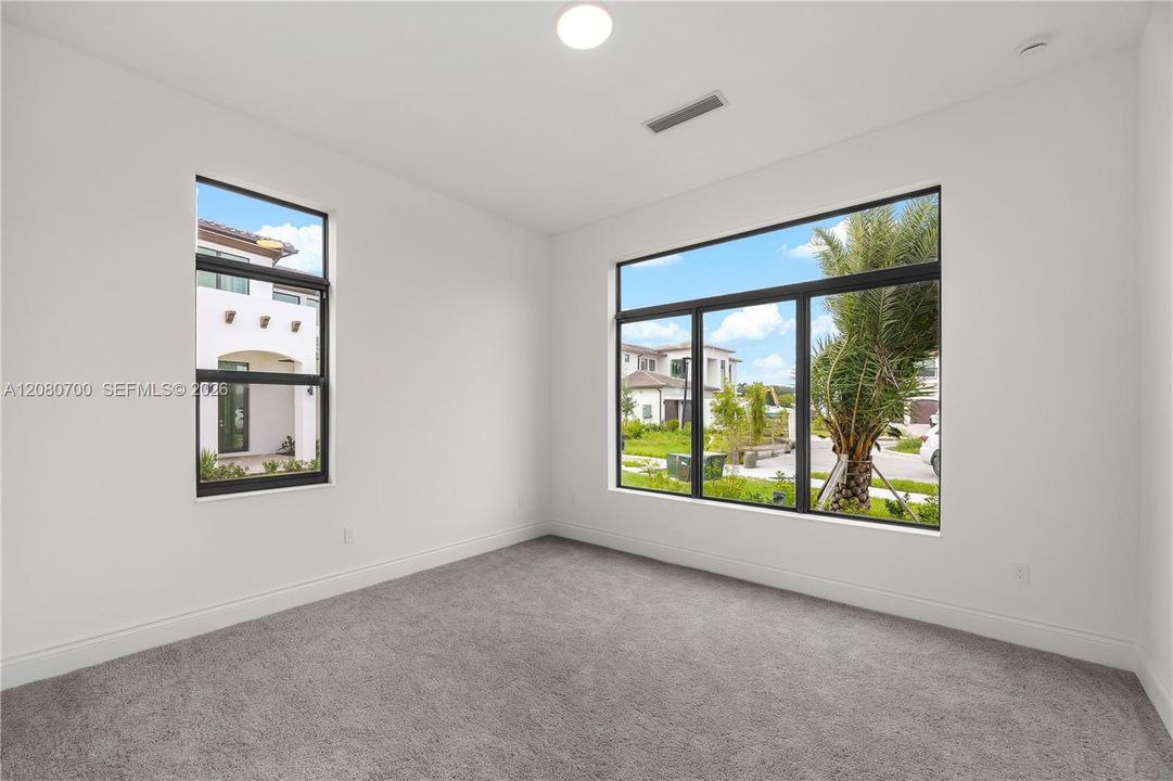Recessed lighting, large format windows, high ceilings, and plush carpeting