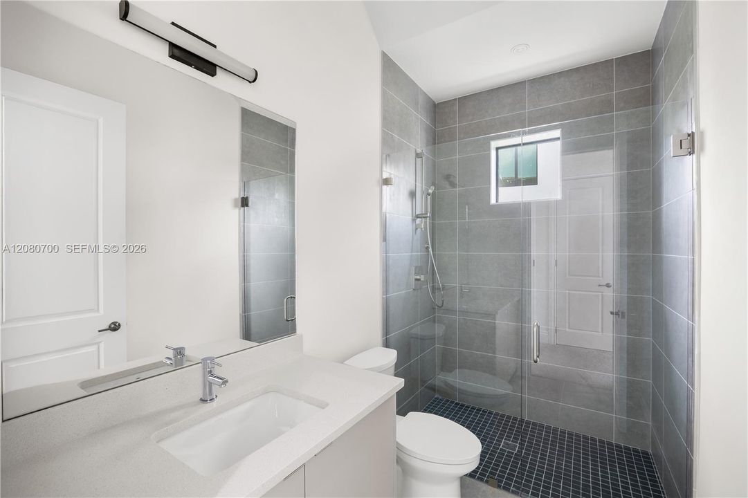 Large vanity mirror with integrated linear lighting