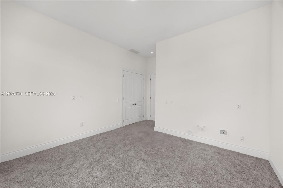 Recessed lighting, light gray wall-to-wall carpeting, and white interior doors
