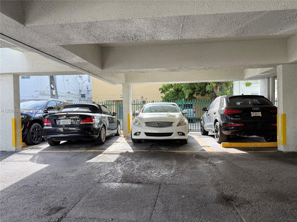Semi Covered assigned parking space - Where white car is parked