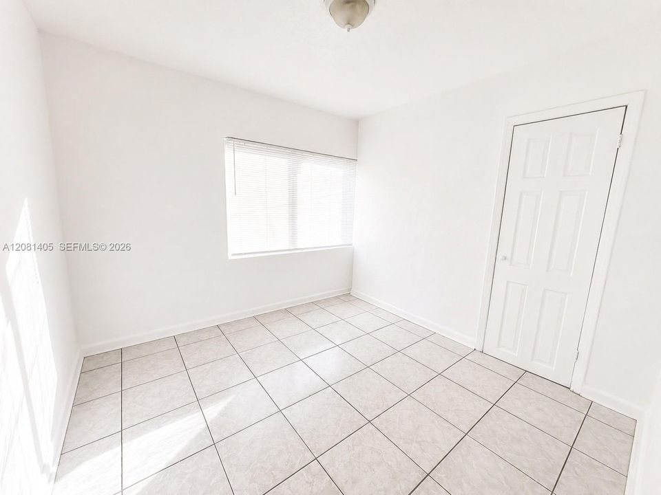 Bright bedroom with tile flooring