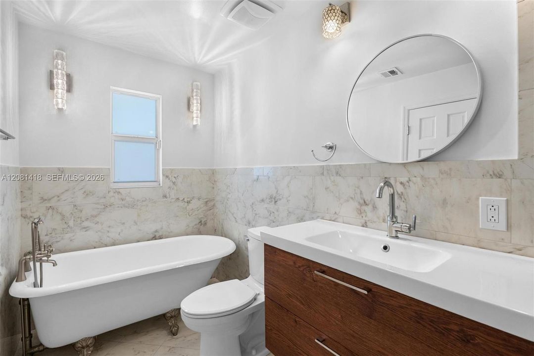 Main-level primary bathroom with tub & shower