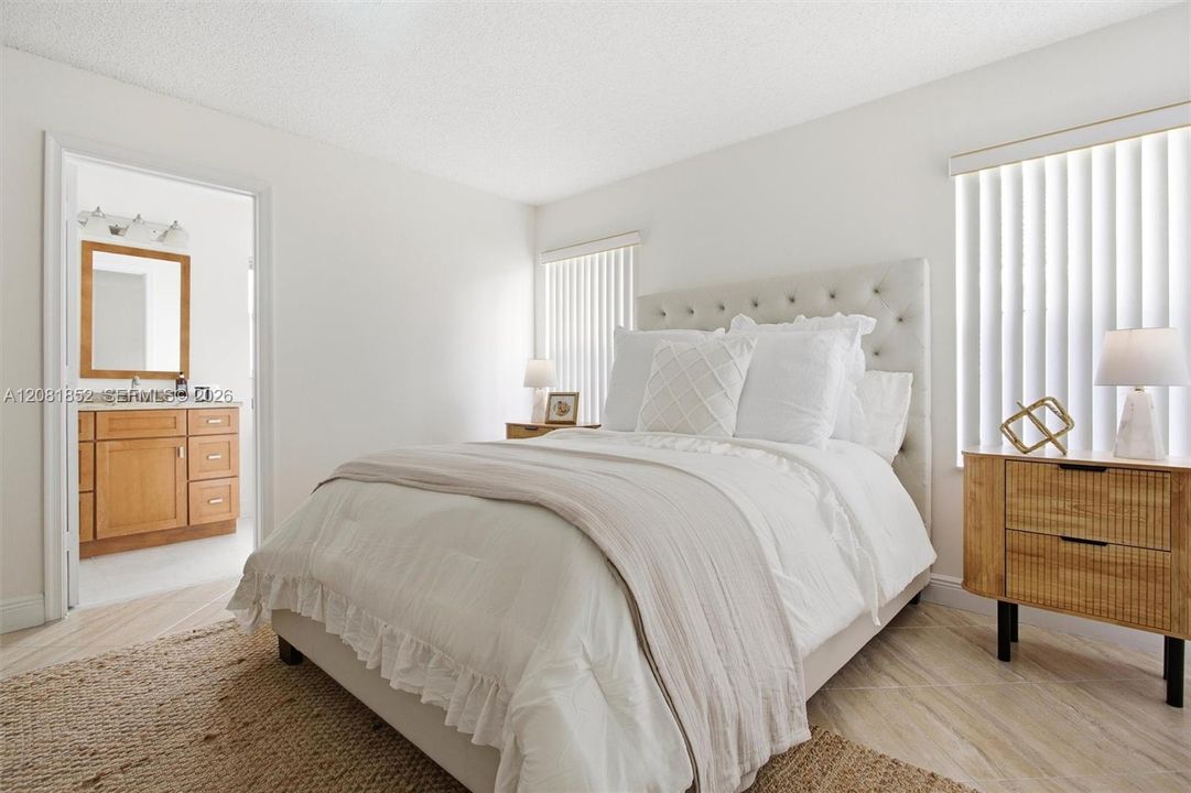 Tranquil primary bedroom featuring elegant furnishings and soft natural light.