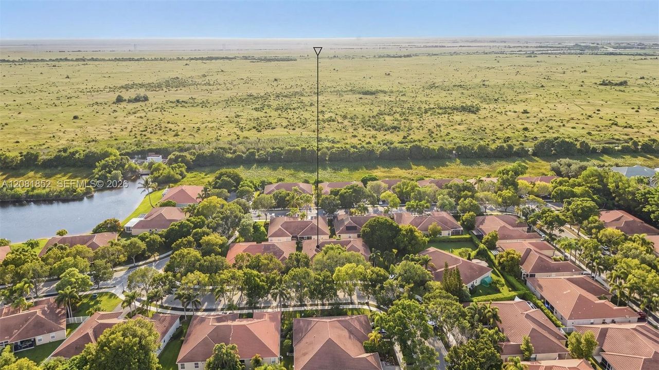 Scenic aerial shot showcasing the tranquil canal and surrounding homes.