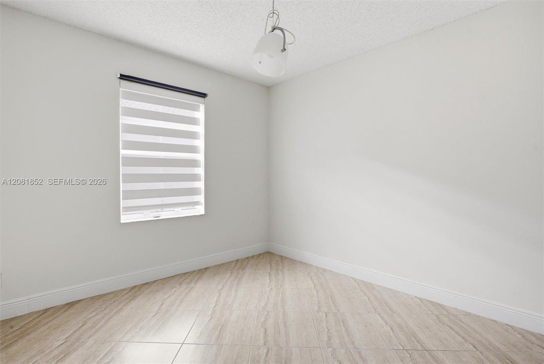 Comfortable bedroom with a large window inviting in natural light.