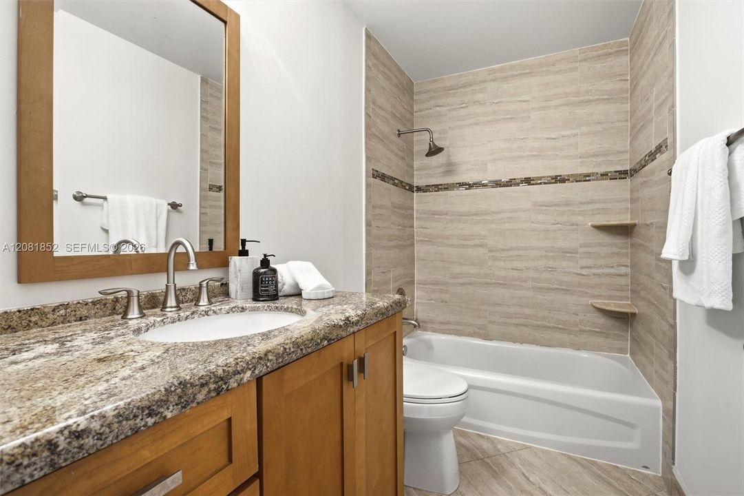 Spa-inspired primary bath with dual vanity and soaking tub/shower combo.