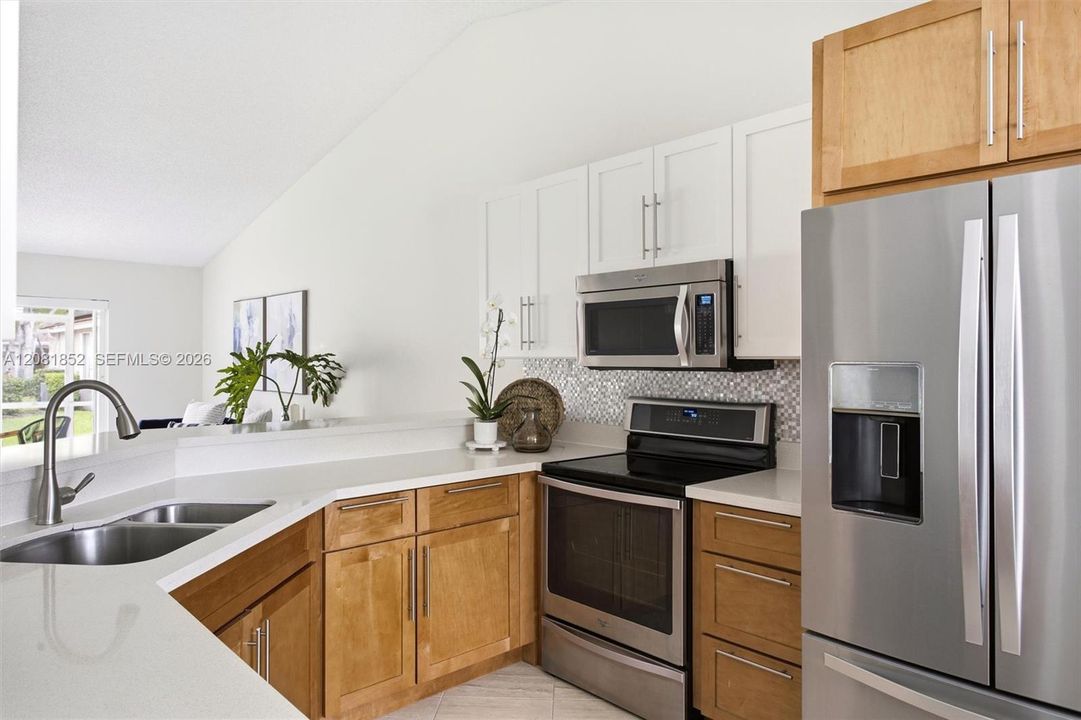 Stainless steel appliances and abundant cabinetry complete this functional kitchen.
