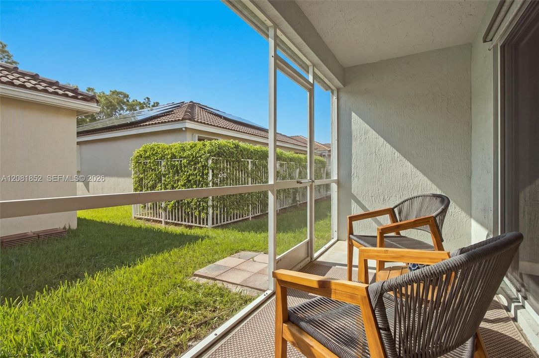 Screened lanai with comfortable seating, perfect for relaxing outdoors.