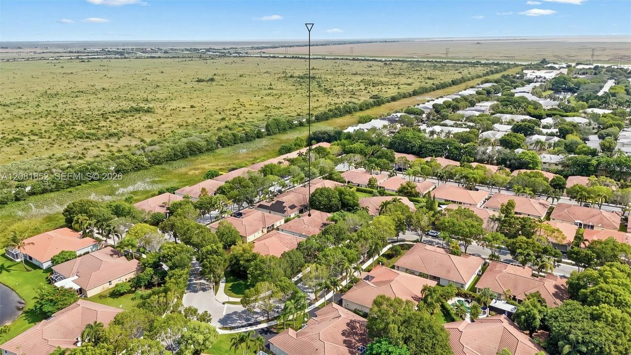 Bird's-eye view highlighting tile rooflines and mature landscaping throughout the neighborhood.