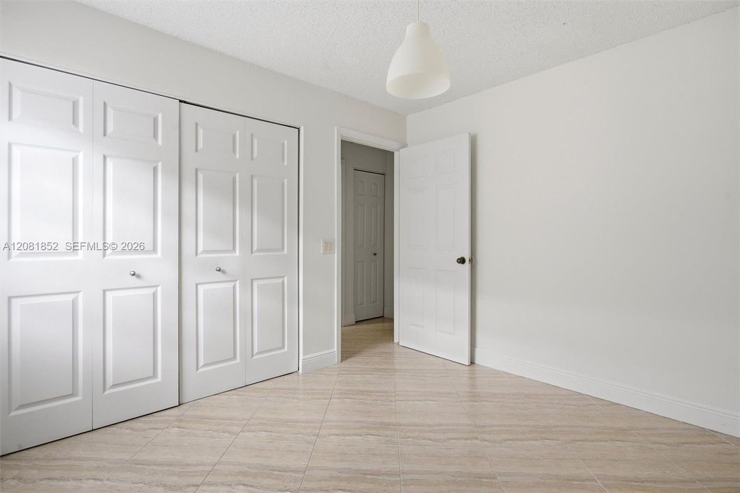 Versatile secondary bedroom with ample closet space and natural light.