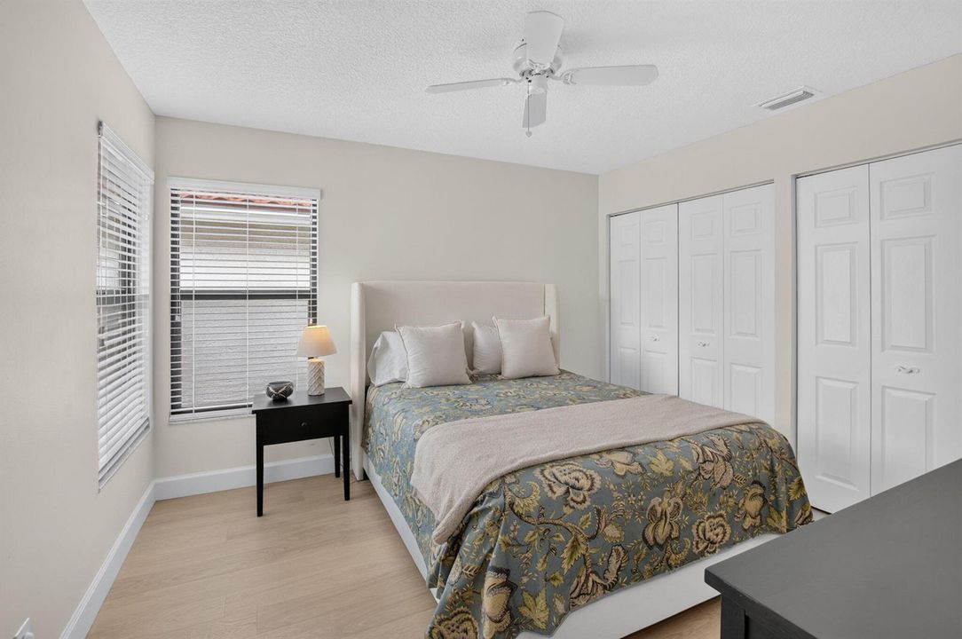 SUNNY GUEST BEDROOM WITH DUAL CLOSETS