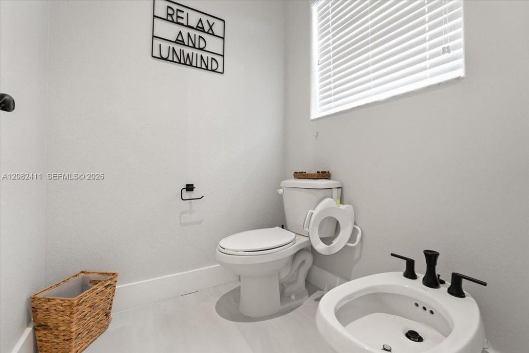 Primary bathroom with a separate toilet and bidet enclosure