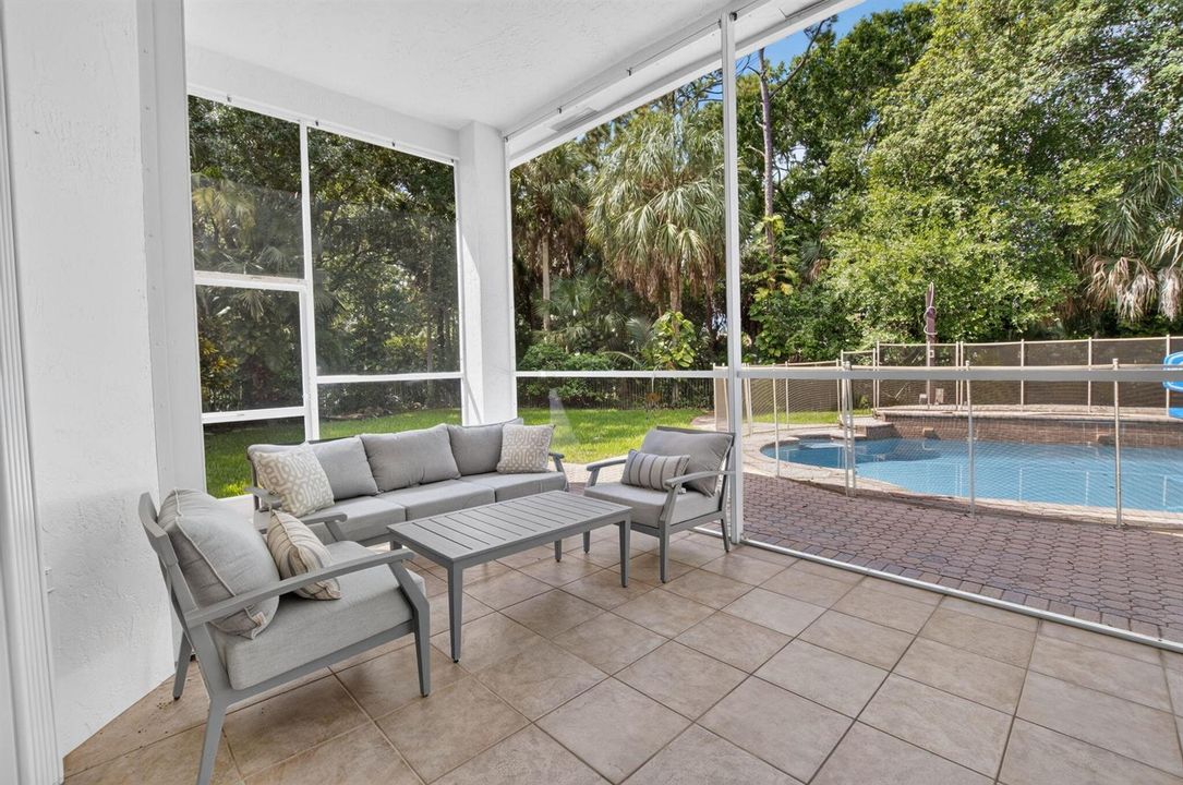 Screened in patio overlooiking the pool