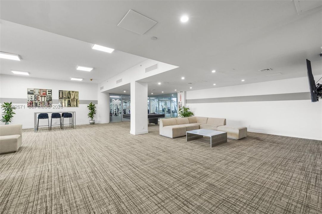 Community/media room with lounge seating.