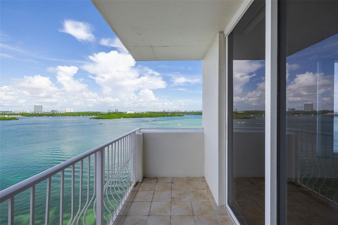 Balcony seating area overlooking the bay and skyline.