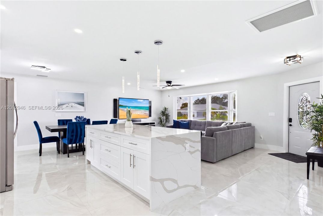 OVERSIZED WATERFALL ISLAND w/ abundant prep space, storage & seating.
