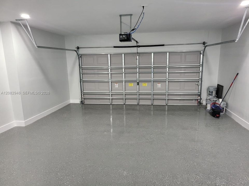 Spacious 2-CAR GARAGE features durable EPOXY FLOORING, bright finished walls & upgraded lighting for a clean, polished & functional space.