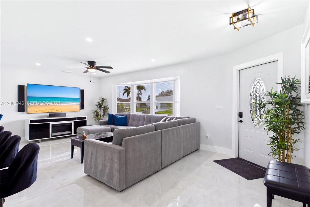 Expansive windows fill the space w/ abundant NATURAL LIGHT. Gorgeous polished MARBLE-LOOK PORCELAIN TILE creates a seamless, sophisticated look throughout.