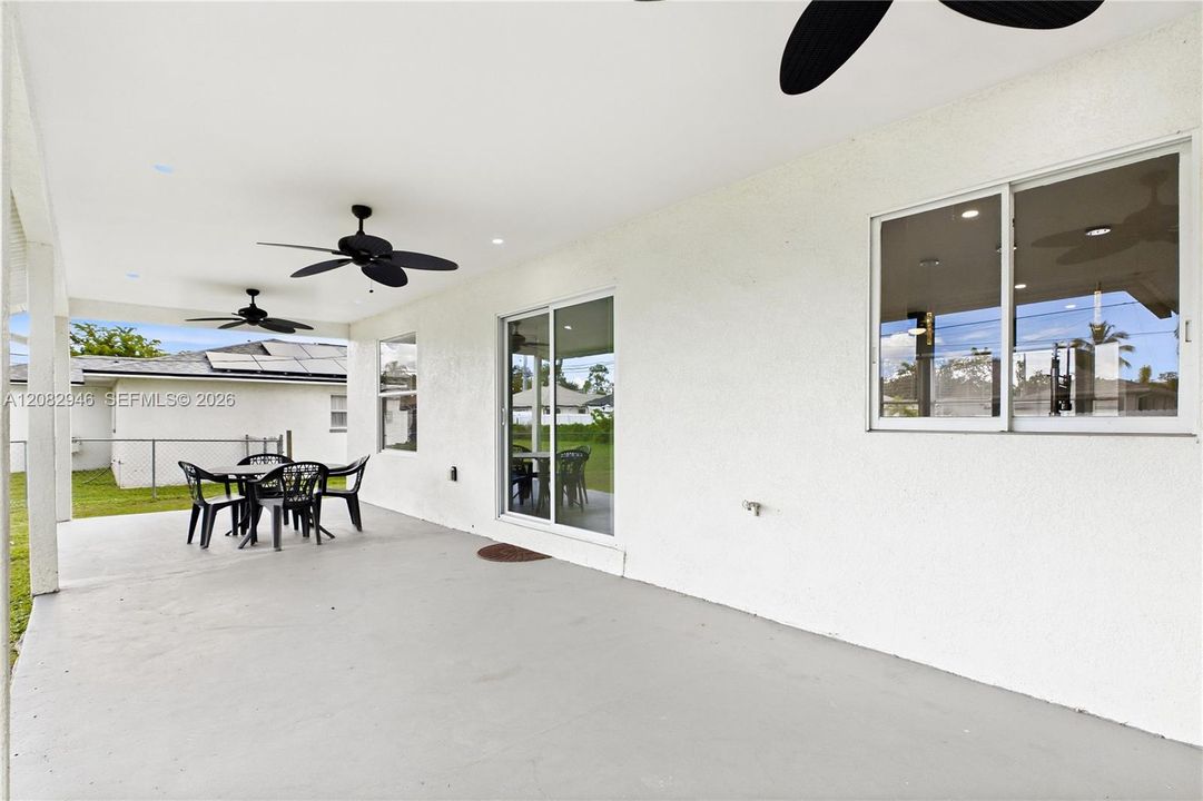 EXPANSIVE COVERED PATIO w/ multiple ceiling fans creates the perfect outdoor living space for dining, grilling, entertaining & enjoying the SWFL weather year-round.