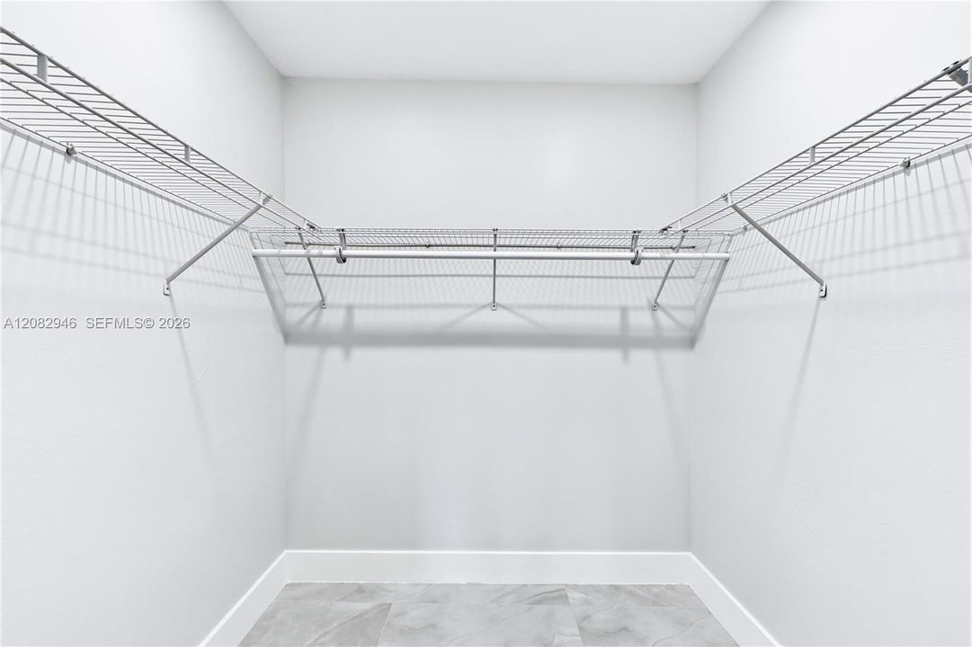 Impressive WALK-IN CLOSET provides abundant shelving & storage space to keep everything beautifully organized.